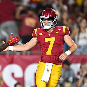 Sep 7, 2024; Los Angeles, California, USA; USC Trojans quarterback Miller Moss (7) celebrates with USC Trojans wide receiver Kyron Hudson (10) after scoring a touchdown against Utah State Aggies during the first quarter at United Airlines Field at Los Angeles Memorial Coliseum. Mandatory Credit: Jonathan Hui-Imagn Images