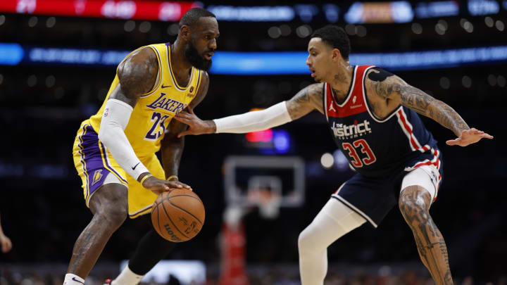 Apr 3, 2024; Washington, District of Columbia, USA; Los Angeles Lakers forward LeBron James (23) drives to the basket as Washington Wizards forward Kyle Kuzma (33) defends in the first half at Capital One Arena. Mandatory Credit: Geoff Burke-USA TODAY Sports