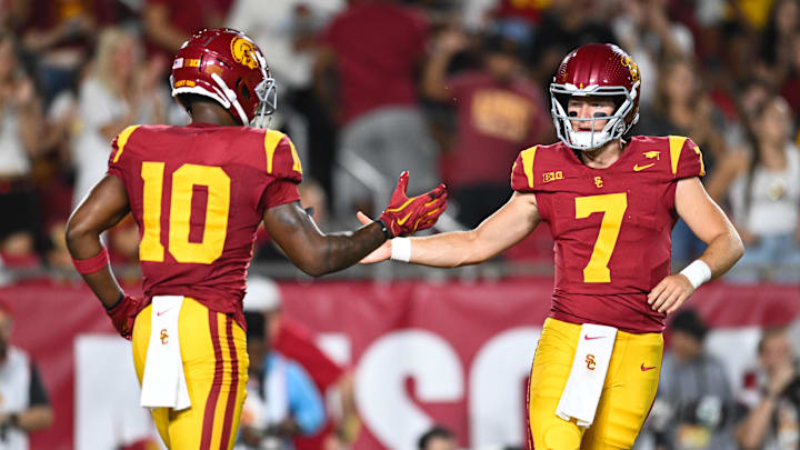 Sep 7, 2024; Los Angeles, California, USA; USC Trojans quarterback Miller Moss (7) celebrates with USC Trojans wide receiver Kyron Hudson (10) after scoring a touchdown against Utah State Aggies during the first quarter at United Airlines Field at Los Angeles Memorial Coliseum. Mandatory Credit: Jonathan Hui-Imagn Images