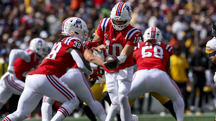 Sep 21, 2025; Foxborough, Massachusetts, USA; New England Patriots quarterback Drake Maye (10) hands off the ball to New England Patriots running back Rhamondre Stevenson (38) during the first quarter at Gillette Stadium. Mandatory Credit: Paul Rutherford-Imagn Images Sep 21, 2025; Foxborough, Massachusetts, USA; New England Patriots quarterback Drake Maye (10) hands off the ball to New England Patriots running back Rhamondre Stevenson (38) during the first quarter at Gillette Stadium. Mandatory Credit: Paul Rutherford-Imagn Images