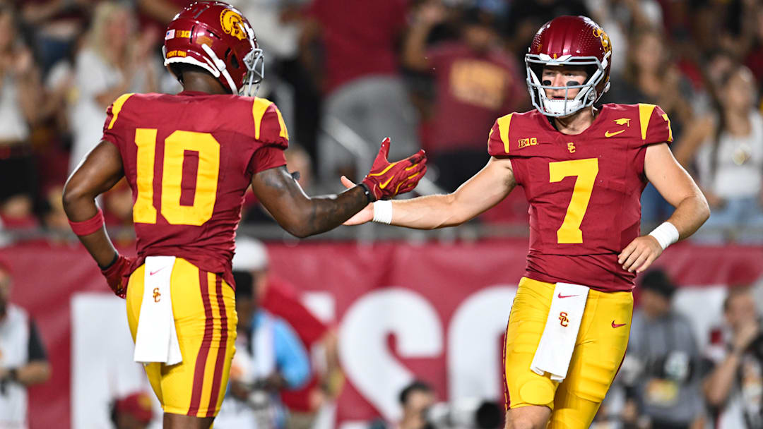 Sep 7, 2024; Los Angeles, California, USA; USC Trojans quarterback Miller Moss (7) celebrates with USC Trojans wide receiver Kyron Hudson (10) after scoring a touchdown against Utah State Aggies during the first quarter at United Airlines Field at Los Angeles Memorial Coliseum.