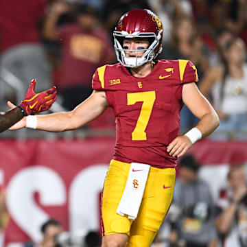 Sep 7, 2024; Los Angeles, California, USA; USC Trojans quarterback Miller Moss (7) celebrates with USC Trojans wide receiver Kyron Hudson (10) after scoring a touchdown against Utah State Aggies during the first quarter at United Airlines Field at Los Angeles Memorial Coliseum.