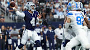 Dallas Cowboys quarterback Dak Prescott throws as Detroit Lions defensive end Aidan Hutchinson rushes.