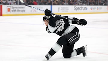 Apr 7, 2025; Los Angeles, California, USA;  Los Angeles Kings defenseman Jordan Spence (21) shoots the puck during the second period against the Seattle Kraken at Crypto.com Arena. Mandatory Credit: Kiyoshi Mio-Imagn Images