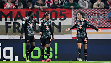 Bayern Munich attacking midfielder Jamal Musiala celebrating with Alphonso Davies and Serge Gnabry during the 4-0 win against Mainz in DFB Pokal.