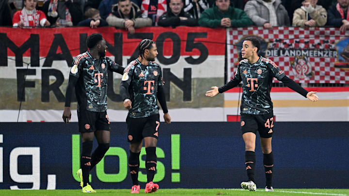 Bayern Munich attacking midfielder Jamal Musiala celebrating with Alphonso Davies and Serge Gnabry during the 4-0 win against Mainz in DFB Pokal.