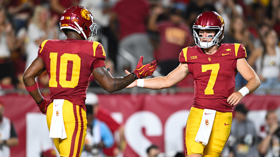 Sep 7, 2024; Los Angeles, California, USA; USC Trojans quarterback Miller Moss (7) celebrates with USC Trojans wide receiver Kyron Hudson (10) after scoring a touchdown against Utah State Aggies during the first quarter at United Airlines Field at Los Angeles Memorial Coliseum. Mandatory Credit: Jonathan Hui-Imagn Images