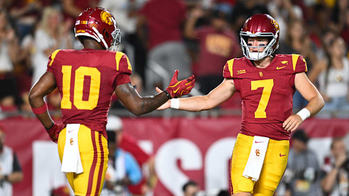 Sep 7, 2024; Los Angeles, California, USA; USC Trojans quarterback Miller Moss (7) celebrates with USC Trojans wide receiver Kyron Hudson (10) after scoring a touchdown against Utah State Aggies during the first quarter at United Airlines Field at Los Angeles Memorial Coliseum. Mandatory Credit: Jonathan Hui-Imagn Images