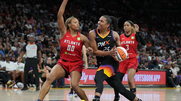 A photo of Alyssa Thomas smiling while she drives into the lane