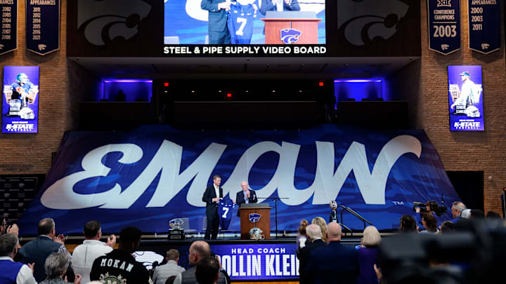 Kansas State new head football coach Collin Klein holds a jersey given by athletic director Gene Taylor during his introduction ceremony at Morgan Family Arena on Dec. 5, 2025.