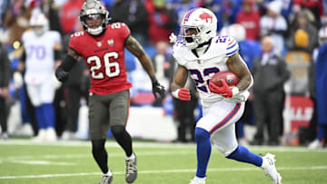 Nov 16, 2025; Orchard Park, New York, USA;  Buffalo Bills running back Ray Davis (22) runs the ball against Tampa Bay Buccaneers safety Kaevon Merriweather (26)  during the second quarter of the game at Highmark Stadium. 