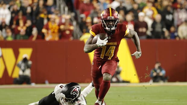 Washington Commanders wide receiver Olamide Zaccheaus (14) runs with the ball