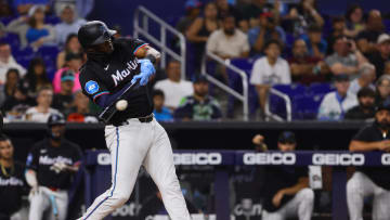 Jul 19, 2024; Miami, Florida, USA; Miami Marlins designated hitter Josh Bell (9) hits an RBI single against the New York Mets during the third inning at loanDepot Park. Mandatory Credit: Sam Navarro-USA TODAY Sports