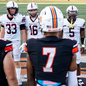 Dowling Catholic captains stand across from Valley captains during a high school football game between Valley and Dowling Catholic on Aug. 29, 2025, at Valley Stadium in West Des Moines, Iowa.