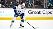 Nov 28, 2025; San Jose, California, USA; Vancouver Canucks defenseman Quinn Hughes (43) controls the puck against the San Jose Sharks in the third period at SAP Center at San Jose. Mandatory Credit: Eakin Howard-Imagn Images