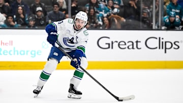 Nov 28, 2025; San Jose, California, USA; Vancouver Canucks defenseman Quinn Hughes (43) controls the puck against the San Jose Sharks in the third period at SAP Center at San Jose. Mandatory Credit: Eakin Howard-Imagn Images