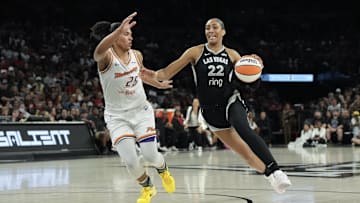 Aug 21, 2025; Las Vegas, Nevada, USA; Las Vegas Aces center A'ja Wilson (22) dribbles against Phoenix Mercury forward Alyssa Thomas (25) in the third quarter of their game at Michelob Ultra Arena. Mandatory Credit: Candice Ward-Imagn Images