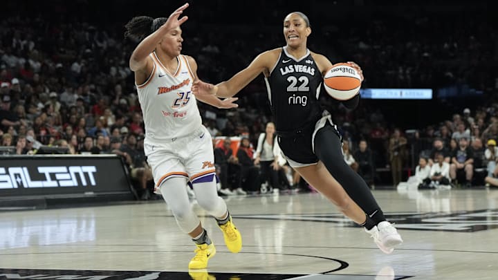 Aug 21, 2025; Las Vegas, Nevada, USA; Las Vegas Aces center A'ja Wilson (22) dribbles against Phoenix Mercury forward Alyssa Thomas (25) in the third quarter of their game at Michelob Ultra Arena. Mandatory Credit: Candice Ward-Imagn Images