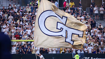 Sep 20, 2025; Atlanta, Georgia, USA; Georgia Tech Yellow Jackets cheerleader runs a flag against the Temple Owls in the third quarter at Bobby Dodd Stadium at Hyundai Field. Mandatory Credit: Brett Davis-Imagn Images