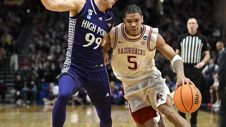 Mar 21, 2026; Portland, OR, USA; Arkansas Razorbacks guard Darius Acuff Jr. (5) drives against High Point Panthers guard Chase Johnston (99) in the second half during a second round game of the men's 2026 NCAA Tournament at Moda Center. Mandatory Credit: Troy Wayrynen-Imagn Images