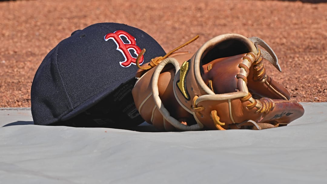 May 10, 2025; Kansas City, Missouri, USA;  A general view of a Boston Red Sox's cap and glove on the field before a game against the Kansas City Royals at Kauffman Stadium. Mandatory Credit: Peter Aiken-Imagn Images
