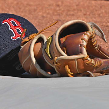 May 10, 2025; Kansas City, Missouri, USA;  A general view of a Boston Red Sox's cap and glove on the field before a game against the Kansas City Royals at Kauffman Stadium. Mandatory Credit: Peter Aiken-Imagn Images