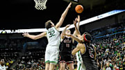 Mar 4, 2025; Eugene, Oregon, USA; Oregon Ducks center Nate Bittle (32) blocks a shot by Indiana Hoosiers forward Luke Goode (10) during the second half at Matthew Knight Arena. Mandatory Credit: Craig Strobeck-Imagn Images