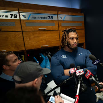 Tennessee Titans offensive tackle JC Latham gives an interview as the team cleans out their locker room