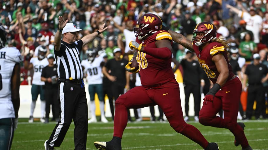 Oct 29, 2023; Landover, Maryland, USA; Washington Commanders defensive tackle Phidarian Mathis (98) celebrates after recovering a fumble against the Philadelphia Eagles during the first half at FedExField. Mandatory Credit: Brad Mills-USA TODAY Sports | Brad Mills-USA TODAY Sports