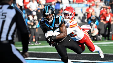 Nov 24, 2024; Charlotte, North Carolina, USA;  Carolina Panthers wide receiver David Moore (83) catches a touchdown as Kansas City Chiefs cornerback Trent McDuffie (22) defends in the third quarter at Bank of America Stadium. Mandatory Credit: Bob Donnan-Imagn Images