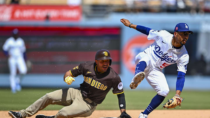 Aug 17, 2025; Los Angeles, California, USA; San Diego Padres outfielder Ramón Laureano (5) slides into second base against Los Angeles Dodgers shortstop Mookie Betts (50) during the sixth inning at Dodger Stadium. Mandatory Credit: Jonathan Hui-Imagn Images
