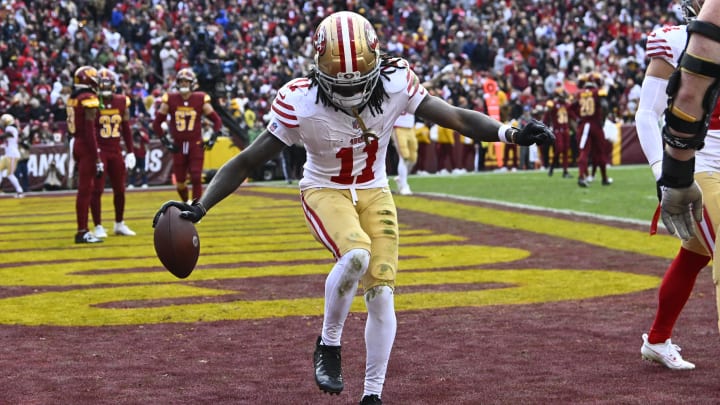 Dec 31, 2023; Landover, Maryland, USA; San Francisco 49ers wide receiver Brandon Aiyuk (11) celebrates after scoring a touchdown  against the Washington Commanders during the second half at FedExField. Mandatory Credit: Brad Mills-USA TODAY Sports