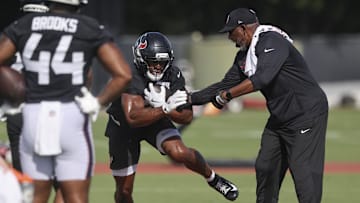 Jul 24, 2025; Houston, TX, USA; Houston Texans running back Nick Chubb (21) and running backs coach Danny Barrett during training camp at Houston Methodist Training Center. Mandatory Credit: Troy Taormina-Imagn Images