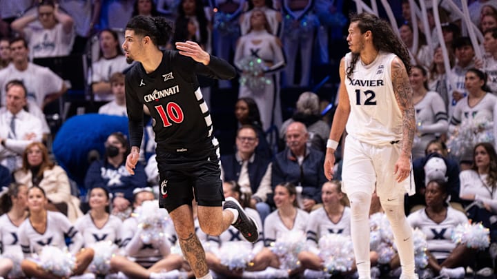 Cincinnati Bearcats guard Shon Abaev (10) gestures after hitting a 3-point shot over Xavier Musketeers forward Tre Carroll (12) in the second half of the NCAA basketball game at the Cintas Center in Cincinnati on Dec. 5, 2025.
