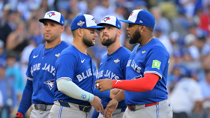 Oct 27, 2025; Los Angeles, California, USA; Toronto Blue Jays second baseman Bo Bichette (11) and first baseman Vladimir Guerrero Jr. (27) are introduced before game three of the 2025 MLB World Series against the Los Angeles Dodgers at Dodger Stadium. Mandatory Credit: Jayne Kamin-Oncea-Imagn Images