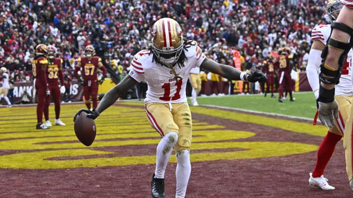 Dec 31, 2023; Landover, Maryland, USA; San Francisco 49ers wide receiver Brandon Aiyuk (11) celebrates after scoring a touchdown  against the Washington Commanders during the second half at FedExField. Mandatory Credit: Brad Mills-USA TODAY Sports