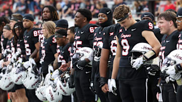 Nov 1, 2025; Houston, Texas, USA; Before the game against the West Virginia Mountaineers Houston Cougars linebacker Corey Platt Jr. (9) stands for a moment of silence for Houston coach Kurt Hester at TDECU Stadium. The Houston Cougars' strength coach who died was Kurt Hester, the Director of Strength and Performance. Hester passed away on October 25, 2025, from stage IV melanoma after an eight-month battle with the diseaseMandatory Credit: Thomas Shea-Imagn Images
