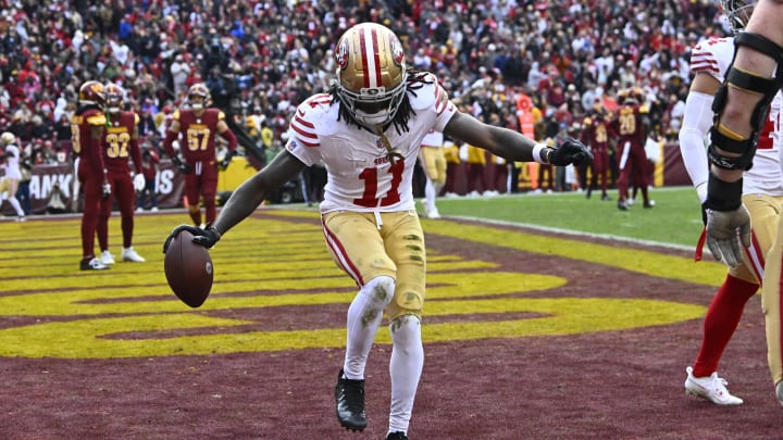 Dec 31, 2023; Landover, Maryland, USA; San Francisco 49ers wide receiver Brandon Aiyuk (11) celebrates after scoring a touchdown  against the Washington Commanders during the second half at FedExField. Mandatory Credit: Brad Mills-USA TODAY Sports