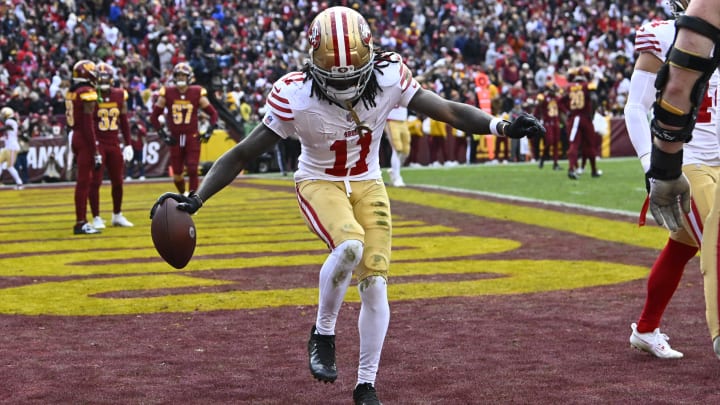 Dec 31, 2023; Landover, Maryland, USA; San Francisco 49ers wide receiver Brandon Aiyuk (11) celebrates after scoring a touchdown  against the Washington Commanders during the second half at FedExField. Mandatory Credit: Brad Mills-USA TODAY Sports