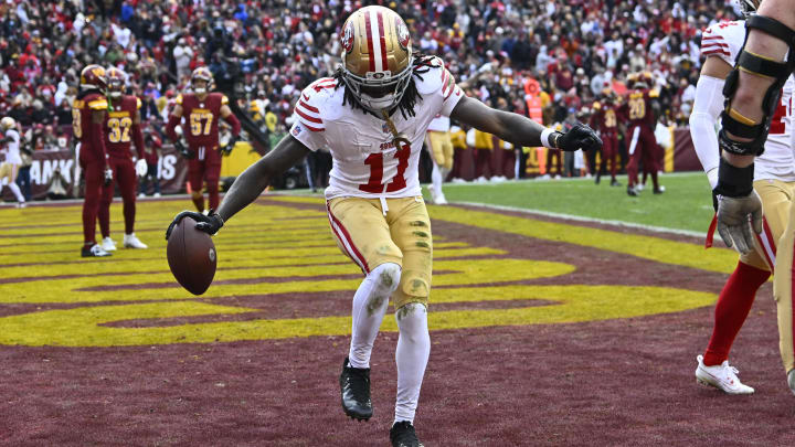 Dec 31, 2023; Landover, Maryland, USA; San Francisco 49ers wide receiver Brandon Aiyuk (11) celebrates after scoring a touchdown  against the Washington Commanders during the second half at FedExField. Mandatory Credit: Brad Mills-USA TODAY Sports