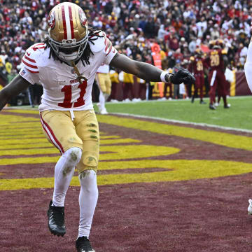 Dec 31, 2023; Landover, Maryland, USA; San Francisco 49ers wide receiver Brandon Aiyuk (11) celebrates after scoring a touchdown  against the Washington Commanders during the second half at FedExField. Mandatory Credit: Brad Mills-USA TODAY Sports