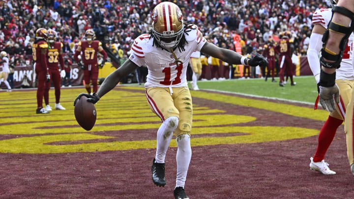Dec 31, 2023; Landover, Maryland, USA; San Francisco 49ers wide receiver Brandon Aiyuk (11) celebrates after scoring a touchdown  against the Washington Commanders during the second half at FedExField. Mandatory Credit: Brad Mills-USA TODAY Sports