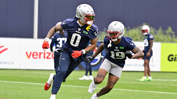 New England Patriots cornerback Christian Gonzalez (0) and cornerback Kobee Minor (19) run a drill during minicamp