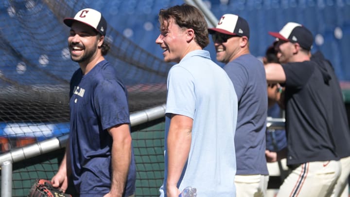 Jul 19, 2024; Cleveland, Ohio, USA; Cleveland Guardians number one draft pick Travis Bazzana, middle, laughs with catcher Austin Hedges, left, before the game between the Cleveland Guardians and the San Diego Padres at Progressive Field. Mandatory Credit: Ken Blaze-USA TODAY Sports