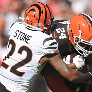 Oct 20, 2024; Cleveland, Ohio, USA; Cincinnati Bengals safety Geno Stone (22) tackles Cleveland Browns running back Nick Chubb (24) during the first half at Huntington Bank Field. Mandatory Credit: Ken Blaze-Imagn Images