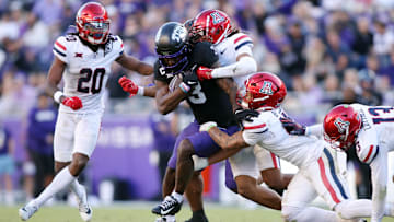 Nov 23, 2024; Fort Worth, Texas, USA; TCU Horned Frogs wide receiver Savion Williams (3) is tackled by the Arizona Wildcats defense in the third quarter at Amon G. Carter Stadium. Mandatory Credit: Tim Heitman-Imagn Images
