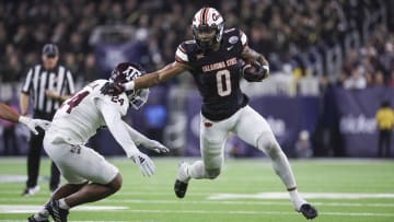 Dec 27, 2023; Houston, TX, USA; Oklahoma State Cowboys running back Ollie Gordon II (0) runs with