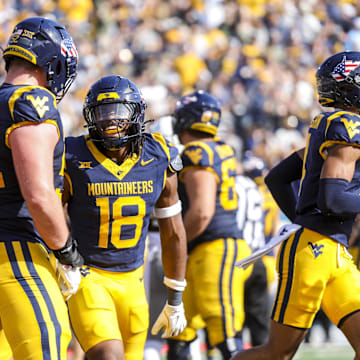 Nov 8, 2025; Morgantown, West Virginia, USA; West Virginia Mountaineers wide receiver Logan Ramper (18) celebrates after scoring a touchdown during the first quarter against the Colorado Buffaloes at Milan Puskar Stadium. Mandatory Credit: Ben Queen-Imagn Images