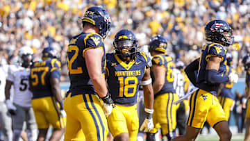Nov 8, 2025; Morgantown, West Virginia, USA; West Virginia Mountaineers bandit Curtis Jones Jr. (18) celebrates after scoring a touchdown during the first quarter against the Colorado Buffaloes at Milan Puskar Stadium. Mandatory Credit: Ben Queen-Imagn Images
