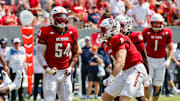 Sep 6, 2025; Raleigh, North Carolina, USA; North Carolina State Wolfpack offensive lineman Rico Jackson (64) celebrates a tackle against Virginia Cavaliers running back J'Mari Taylor (3) during the first half of the game at Carter-Finley Stadium. Mandatory Credit: Jaylynn Nash-Imagn Images